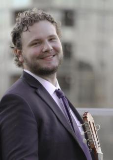 Joseph Douglass holding a guitar