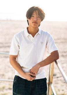 Alvin Lee standing next to a railing outside