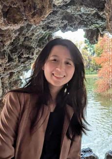 Sammy Lesner in a cave with water behind them